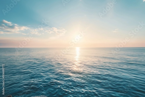 Fototapeta Naklejka Na Ścianę i Meble -  Sunlit rocky coastline with calm sea at sunset