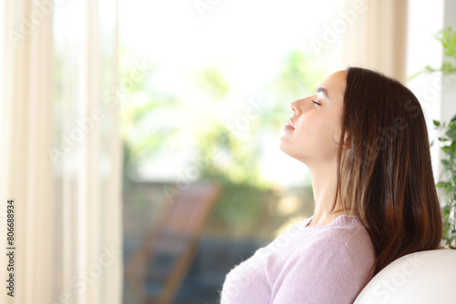 Woman at home breathing sitting on a couch