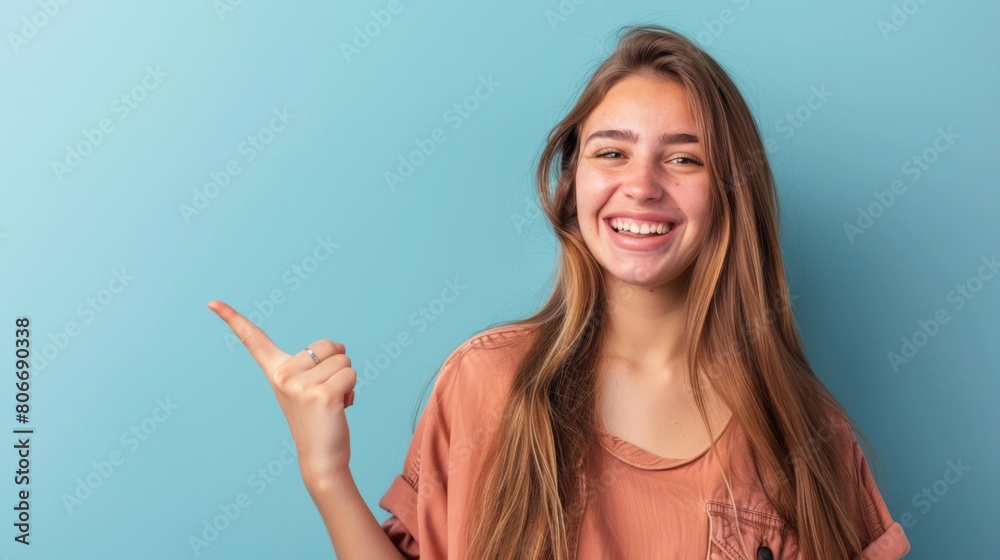 Smiling Young Woman Pointing Sideways Smiling Young Woman Pointing Sideways