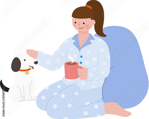 Girl with pajamas sitting and playing with her dog