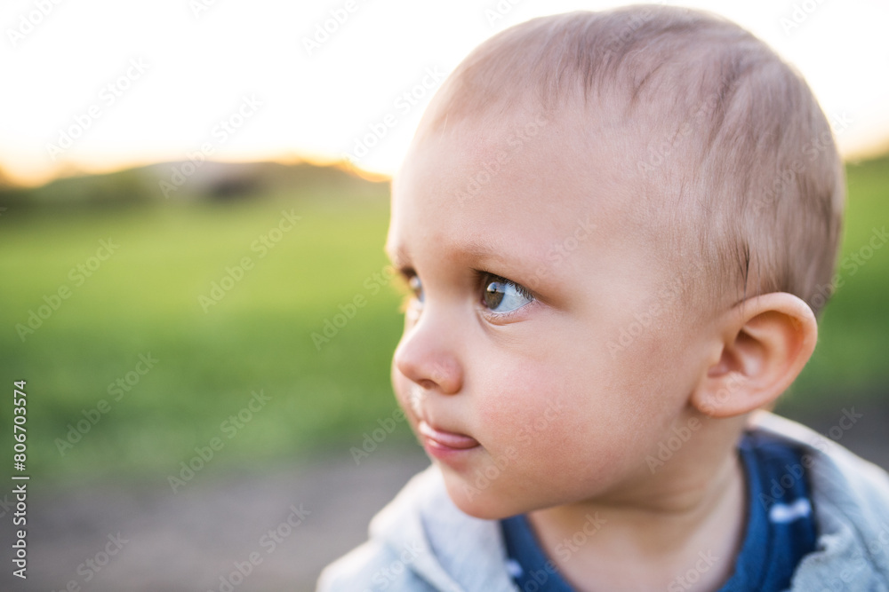 Cute toddler spending time outdoors. Baby on family walk k in spring nature. Happy family moment for new parents Cute toddler spending time outdoors. Baby on family walk k in spring nature. Happy family moment for new parents