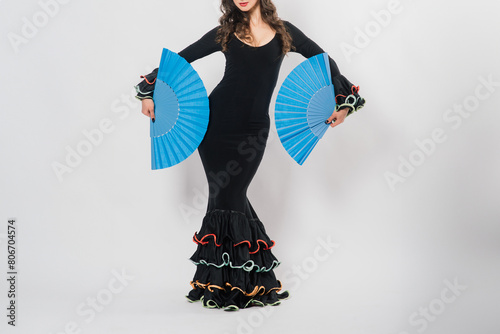 Portrait of beautiful young woman dancing flamenco in studio