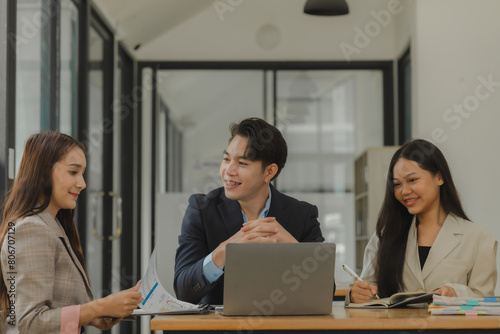 a group of businesspeople is brainstorming in the modern office, working together as a teamwork to share an idea, they are talking about what strategy that they will use for project