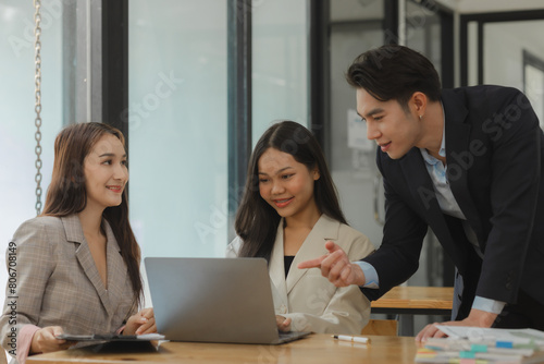 employees are discussing and exchange their idea to solve some miner problem, group of entrepreneurs is planning strategy to increase their income in the office, happy working © Chadaporn