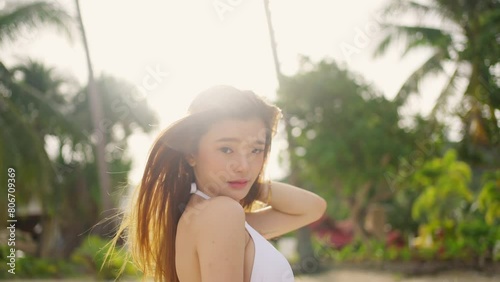 Happy young Asian woman travel nature ocean on summer beach holiday vacation. Attractive girl in bikini enjoy and fun outdoor lifestyle walking and relaxing at tropical island sea beach in sunny day.