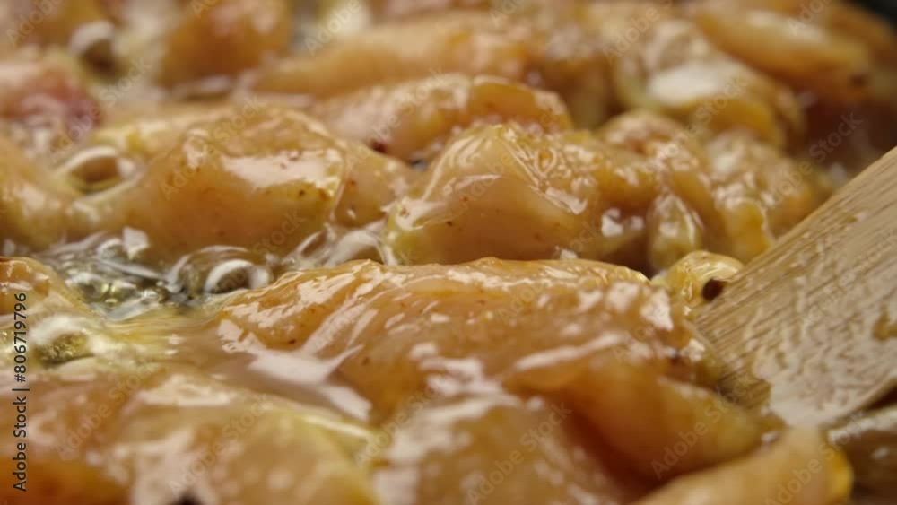 Super close-up of the chicken fillet mixed with spices and sauce and bamboo spoon. High quality 4k footage Super close-up of the chicken fillet mixed with spices and sauce and bamboo spoon. High quality 4k footage