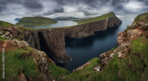 Panorama of Sorvagsvatn lake and cliffs of Traelanipa on Vagar island in sunset, Faroe Islands mountain and ocean landscape