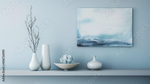 Pale blue accent wall with soft gray floating shelves displaying pale blue decor pieces.