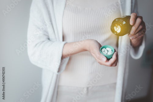 Woman hands pouring pills out of bottle,Women hand holding a medicine