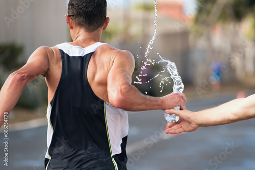 Runner take a water in a marathon race, hydration drinking during a race