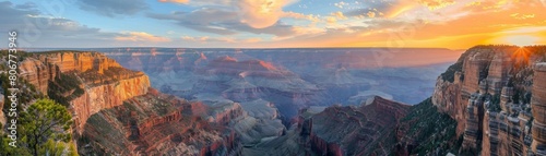 The setting sun casts a golden glow over the rugged cliffs and canyons of the Grand Canyon photo
