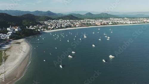 Aerial view of boats anchored in front of the stunning Jurere Beach in Florianopolis, on a beautiful sunny morning. photo