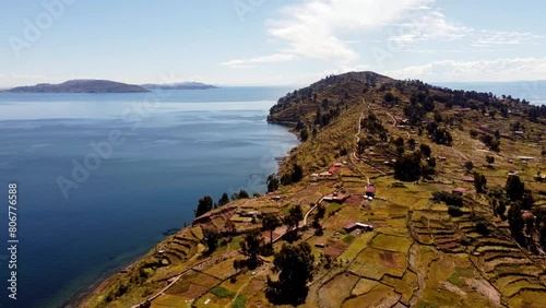 Aerial footage of the terraced fields on Taquile island in Titicaca Lake in Huillanopampa, Peru photo