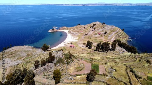 Aerial footage of Taquile Beach and terraced fields on Taquile island in Titicaca Lake, Peru photo