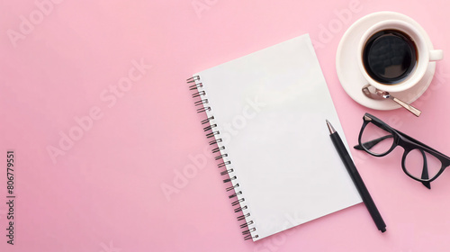 Blank notebook pen eyeglasses and cup of coffee