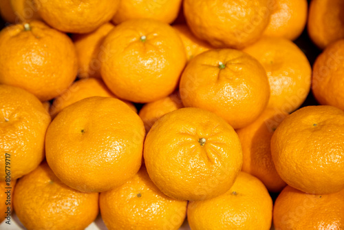 Lots of ripe tangerines. Close up.