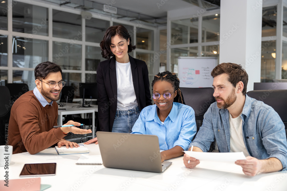Confident business people discussing risky ideas working on laptop in office Confident business people discussing risky ideas working on laptop in office