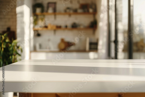 Modern empty white table for montage in blurry modern kitchen