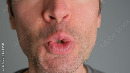 Emotional man bared his teeth, irritability close-up.