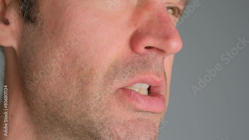 Emotional man bared his teeth, irritability close-up. photo