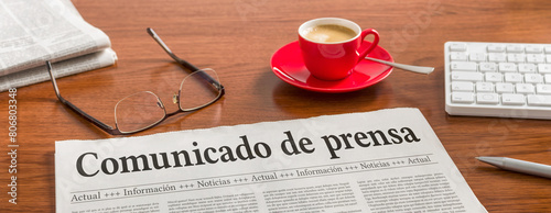 A newspaper on a wooden desk - Press Release in spanish