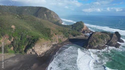 Tasman Lookout And Taitomo Rock On West Coast Of Auckland In Piha, New Zealand. descending drone shot photo