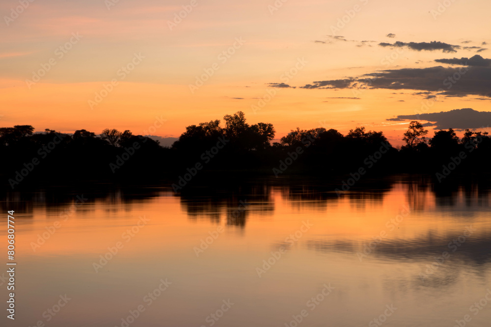 Beautiful panorama sunrise view at the area of the Okavango River near Divundu and Mahango national park. Namibia, Africa. Tourism and vacatins concept. Beautiful panorama sunrise view at the area of the Okavango River near Divundu and Mahango national park. Namibia, Africa. Tourism and vacatins concept.