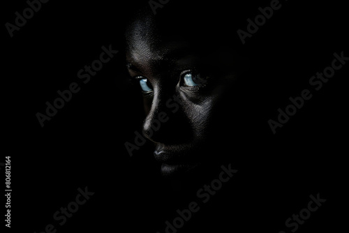 Young african american person in the dark, close up portrait