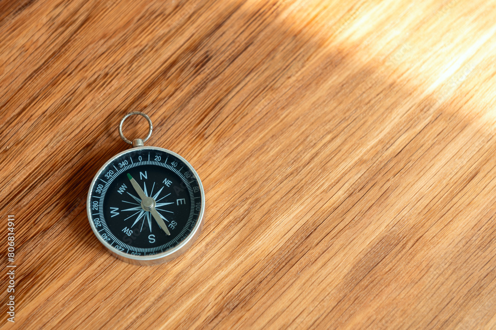 Compass on wooden background with copy space using as direction Compass on wooden background with copy space using as direction