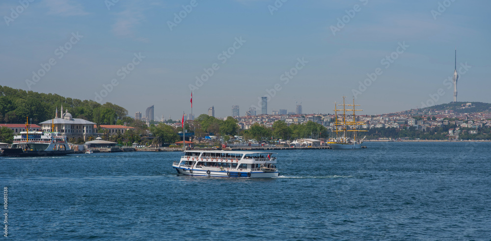 Touristic sightseeing ships in Golden Horn bay against blue sky and clouds. Istanbul, Turkey. During sunny summer day.