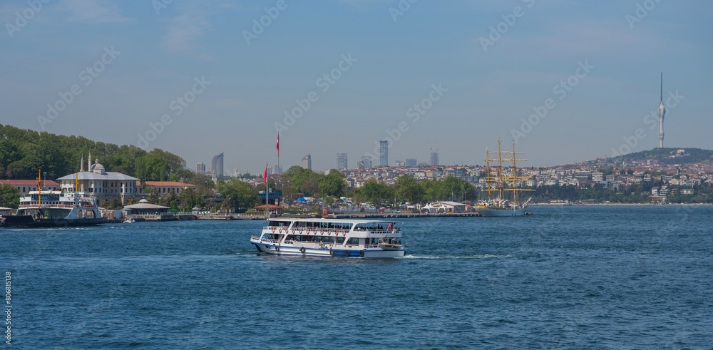 Touristic sightseeing ships in Golden Horn bay against blue sky and clouds. Istanbul, Turkey. During sunny summer day. Touristic sightseeing ships in Golden Horn bay against blue sky and clouds. Istanbul, Turkey. During sunny summer day.