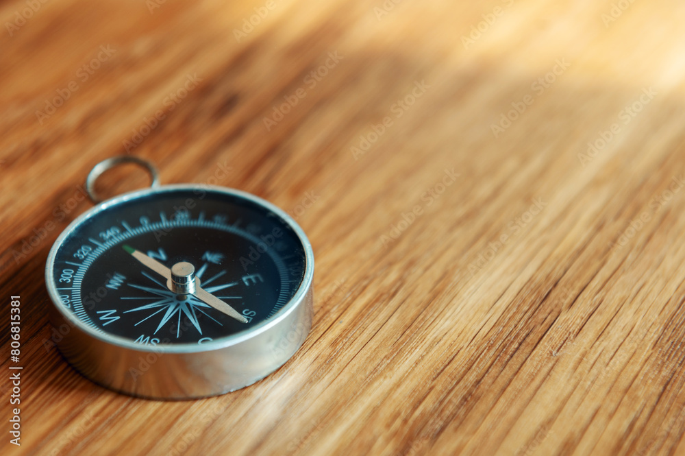 Compass on wooden background with copy space using as direction Compass on wooden background with copy space using as direction