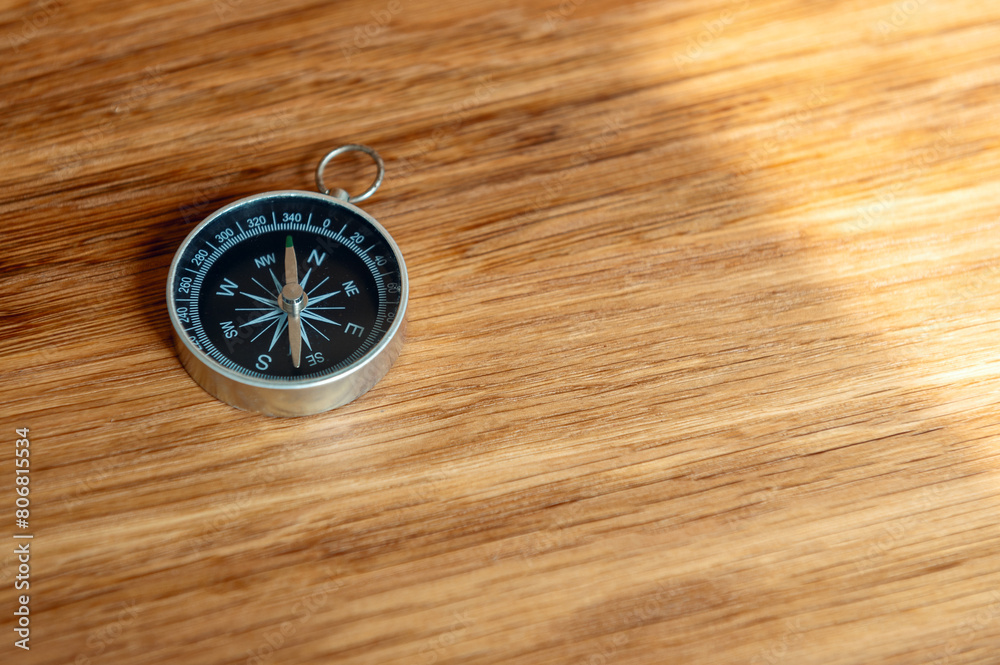 Compass on wooden background with copy space using as direction Compass on wooden background with copy space using as direction