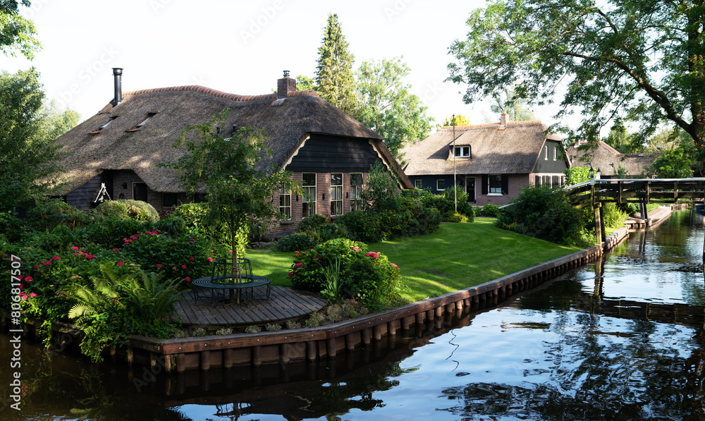 Typical houses of Giethoorn, Netherlands with gardens. Town is know as Typical houses of Giethoorn, Netherlands with gardens. Town is know as
