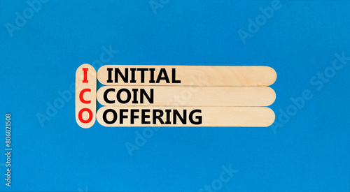 ICO initial coin offering symbol. Concept words ICO initial coin offering on beautiful wooden stick. Beautiful blue background. Business ICO initial coin offering concept. Copy space.