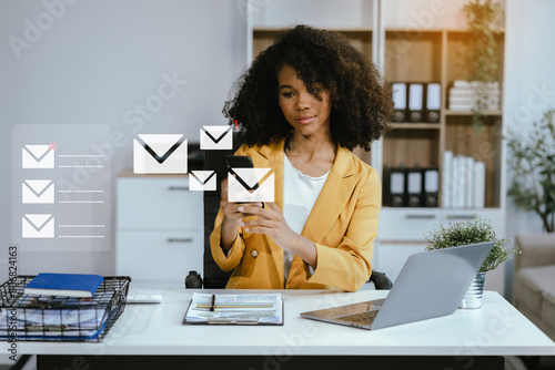 Email notification concept, Female use smartphone and laptop receive message alert in the mailbox. photo