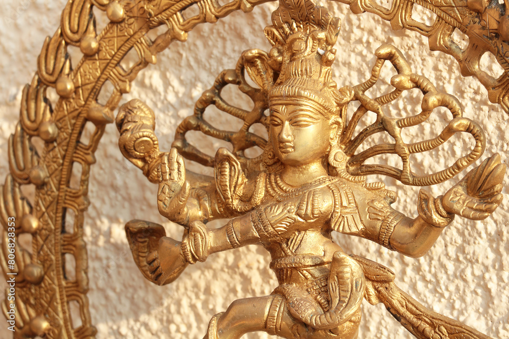 Bronze or gold statue of dancing Shiva. Tandava dance. Traditional Hindu religious figurine. Bronze or gold statue of dancing Shiva. Tandava dance. Traditional Hindu religious figurine.