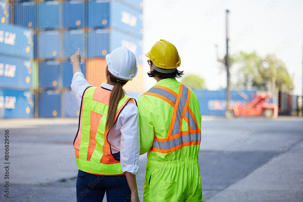 back view workers looking and pointing above in containers warehouse storage