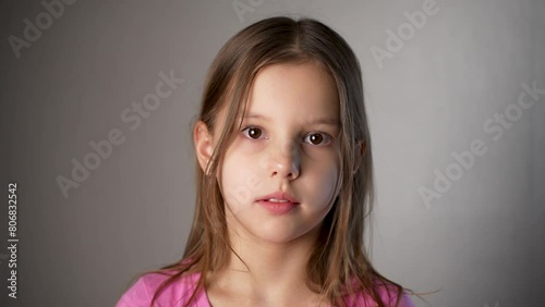 Portrait of a beautiful preschool child girl looking at camera, close-up
