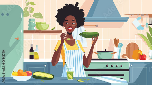 Young AfricanAmerican woman eating cucumber in kitchen photo