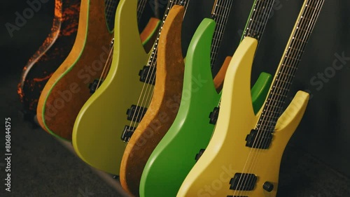 colorful electric guitars leaning on a wall in the studio. High quality 4k footage photo