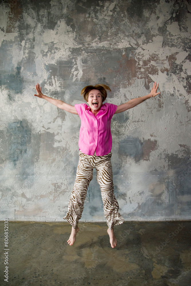 smiling funny emotional beautiful woman in pink shirt having fun on grey background smiling funny emotional beautiful woman in pink shirt having fun on grey background