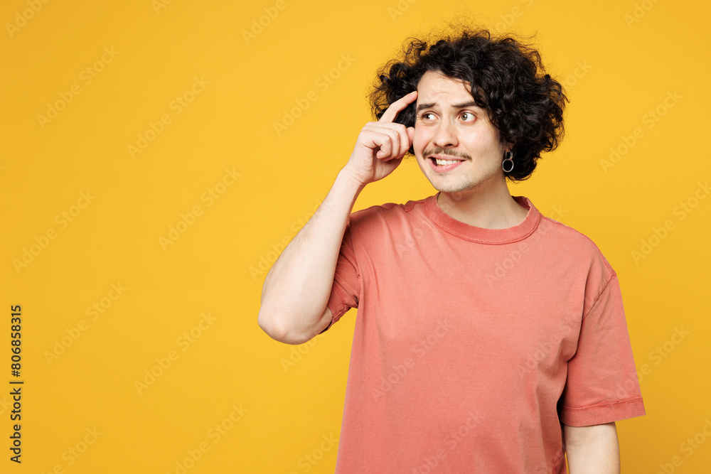 Young upset mistaken puzzled confused sad man he wearing pink t-shirt casual clothes looking aside holding scratch head isolated on plain yellow orange background studio portrait. Lifestyle concept. Young upset mistaken puzzled confused sad man he wearing pink t-shirt casual clothes looking aside holding scratch head isolated on plain yellow orange background studio portrait. Lifestyle concept.