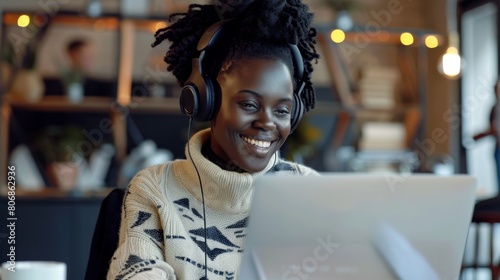Smiling Woman with Headphones at Laptop photo