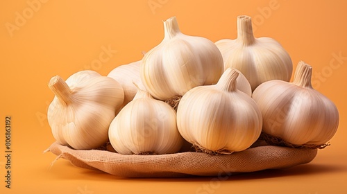 A cluster of garlic bulbs resting on a soft cloth