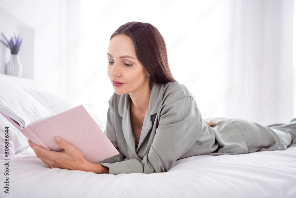 Photo of positive sweet lady grey sleepwear enjoy morning reading book indoors home bedroom Photo of positive sweet lady grey sleepwear enjoy morning reading book indoors home bedroom