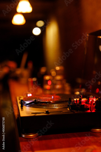 Vinyl records as part of history and a revived musical tradition today. Vinyl in a cafe, playing in a bar, record player at home and on the street. High-quality sound and sound atmosphere