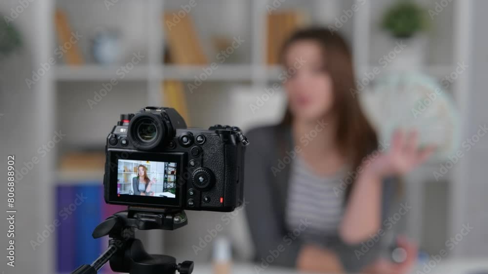 Display of camera recording video blog. Female media influencer showing dollar banknotes to followers. Real time video. Vlogging concept Display of camera recording video blog. Female media influencer showing dollar banknotes to followers. Real time video. Vlogging concept