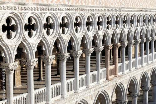 Architectural details and row of gothic columns of Doge's Palace at St Mark's Square in Venice, Italy photo