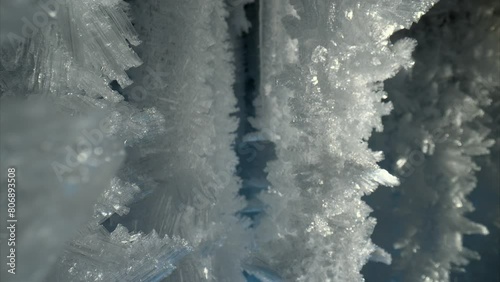 Sharp crystal icicles, ice snowflakes on stalactites inside frozen cave  photo